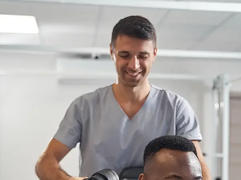 A therapist working on a patient's neck and shoulder