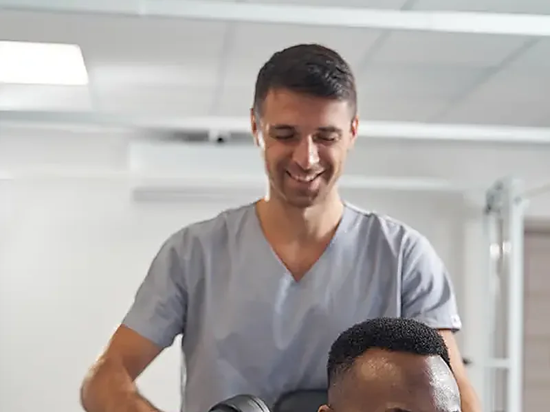A therapist working on a patient's shoulder