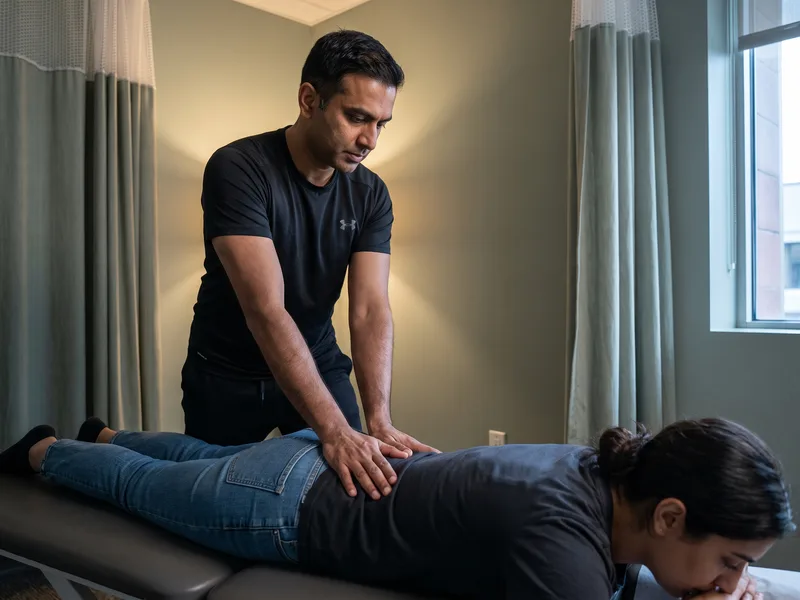 Physical therapist providing hands-on treatment to calm acute pain