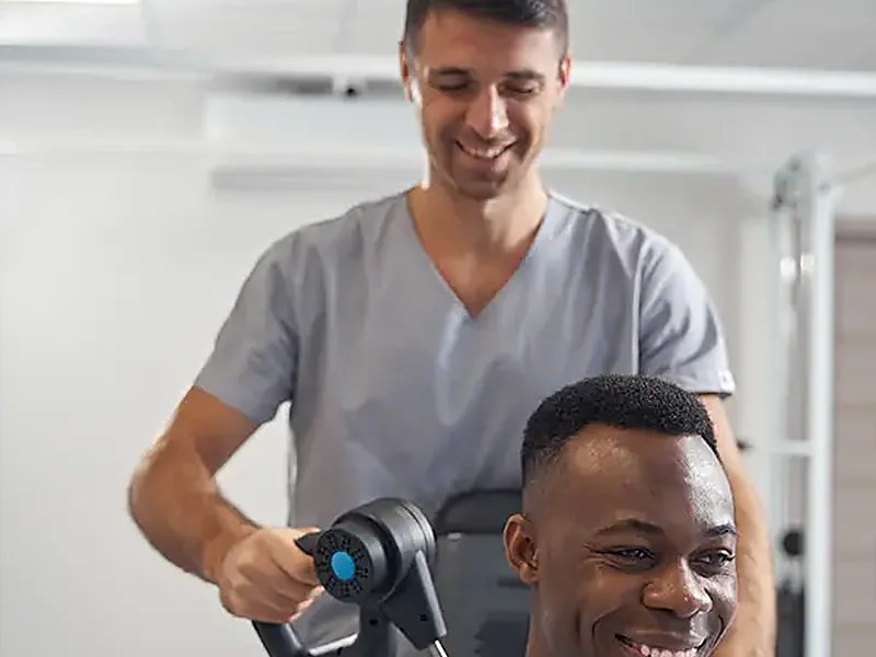 A therapist working hands-on with a seated patient