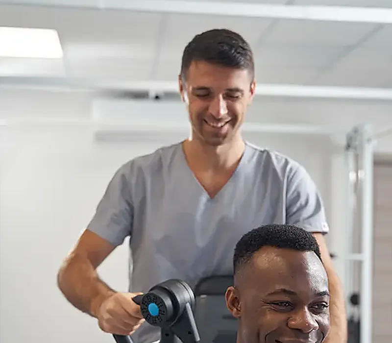 A therapist working hands-on with a seated patient