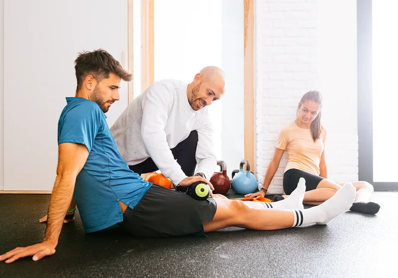 Physical therapist guiding a patient through a hands-on treatment session